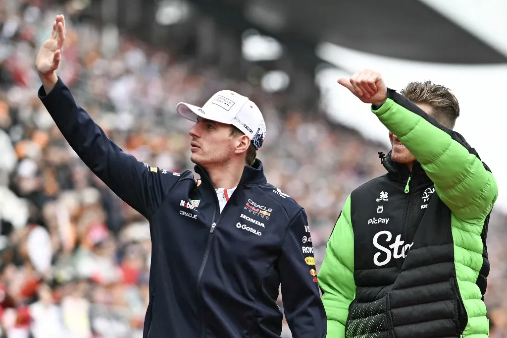 Red Bull Racing's Dutch driver Max Verstappen (L) and Kick Sauber's German driver Nico Hulkenberg wave at the fans during the drivers' parade before the start of the Formula One Japanese Grand Prix at the Suzuka circuit in Suzuka, Mie prefecture, Japan on April 6, 2025. (Photo by MOHD RASFAN / AFP)
