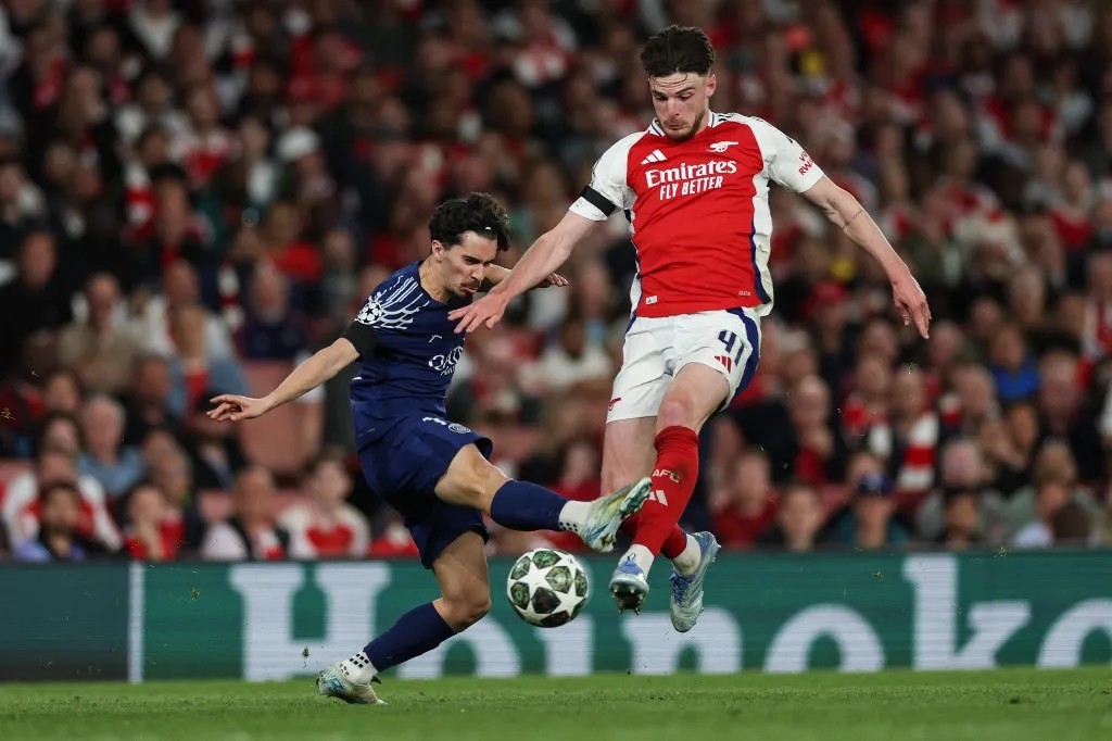 Paris Saint-Germain's Portuguese midfielder #17 Vitinha (L) fights for the ball with Arsenal's English midfielder #41 Declan Rice during the UEFA Champions League Semi-final First Leg football match between Arsenal and Paris Saint-Germain (PSG) at the Emirates Stadium in north London, on April 29, 2025. (Photo by Adrian Dennis / AFP)