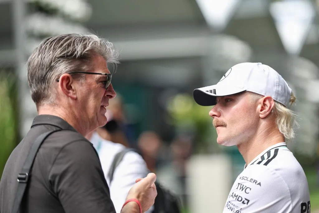 In Melbourne, Australia, on March 13, Forma–12025, Graeme Lowdon of Great Britain and the Cadillac F1 Team talks with Valtteri Bottas of Finland and the Mercedes-AMG PETRONAS F1 Team during previews ahead of the F1 Grand Prix of Australia at Albert Park Circuit. (Photo by Qian Jun/Paddocker) (Photo by Paddocker/NurPhoto) (Photo by Paddocker / NurPhoto / NurPhoto via AFP)