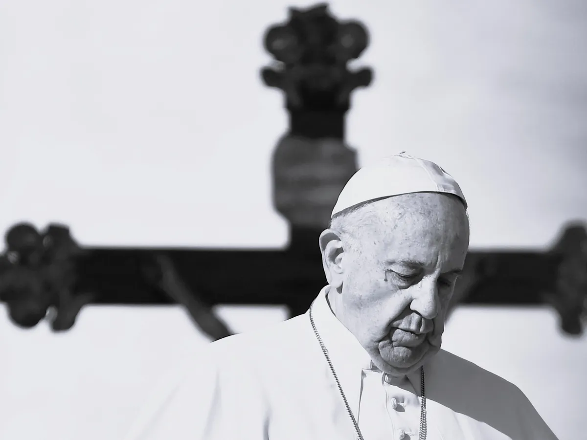(FILES) Pope Francis walks past a crucifix, during a weekly general audience at St Peter's square in Vatican on November 16, 2016. Pope Francis died on April 21, 2025 announced The Vatican. (Photo by ALBERTO PIZZOLI / AFP)
