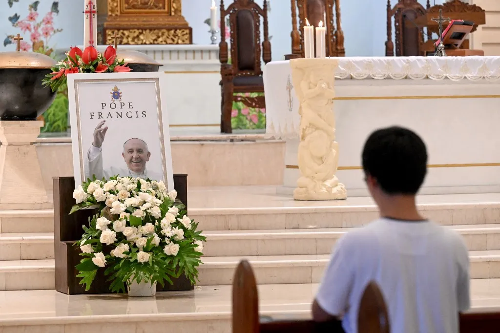 A portrait of Pope Francis is seen displayed at the altar of St. Francis Xavier Catholic Church in Kuta on Indonesia's resort island of Bali on April 22, 2025, a day after his death. Pope Francis died of a stroke, the Vatican announced hours after the death on April 21 of the 88-year-old reformer who inspired devotion but riled traditionalists during 12 years leading the Catholic Church. (Photo by SONNY TUMBELAKA / AFP)