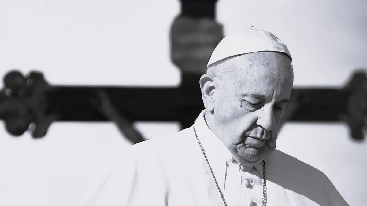 (FILES) Pope Francis walks past a crucifix, during a weekly general audience at St Peter's square in Vatican on November 16, 2016. Pope Francis died on April 21, 2025 announced The Vatican. (Photo by ALBERTO PIZZOLI / AFP)