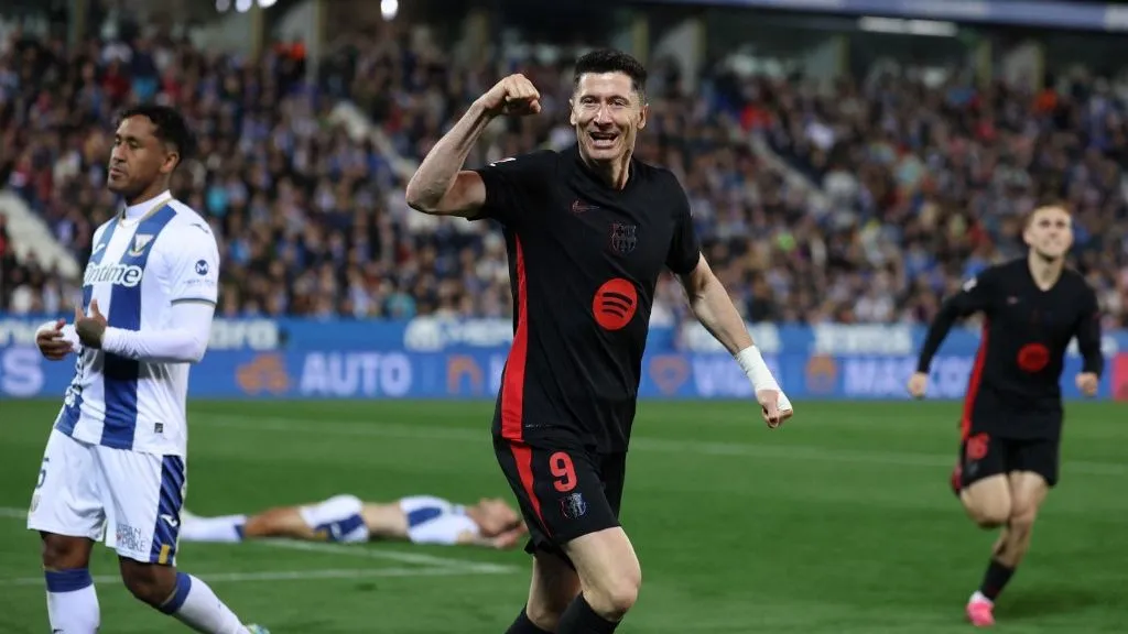 Barcelona's Polish forward #09 Robert Lewandowski celebrates after Leganes' Spanish defender #03 Jorge Saenz scored an own goal during the Spanish league football match between Club Deportivo Leganes SAD and FC Barcelona at the Estadio Municipal Butarque in Leganes, near Madrid, on April 12, 2025. (Photo by Thomas COEX / AFP)