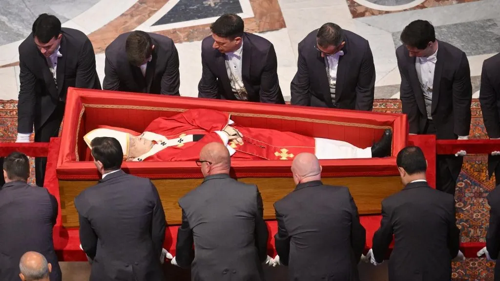This photograph shows pallbearers holding Pope Francis' coffin (bottom) during a ceremony inside St Peter's Basilica following the procession of the late Pope's coffin from the chapel of Santa Marta to St Peter's Basilica, in the Vatican on April 23, 2025. The Pope died of a stroke, the Vatican announced hours after the death on April 21, 2025, of the 88-year-old reformer who inspired devotion but riled traditionalists during 12 years leading the Catholic Church. (Photo by Alessandro DI MEO / POOL / AFP)