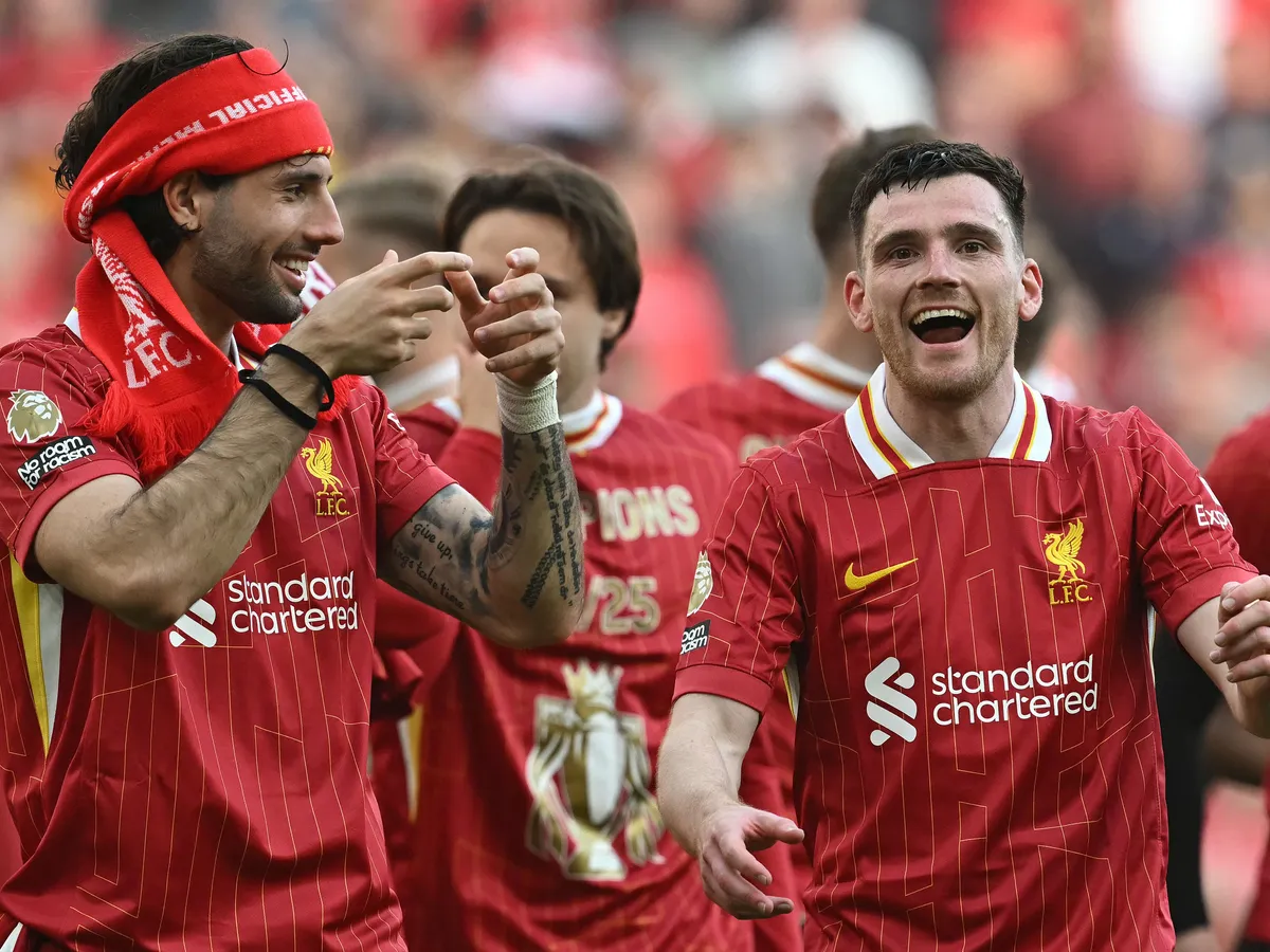 Liverpool's Hungarian midfielder #08 Dominik Szoboszlai (L) and Liverpool's Scottish defender #26 Andrew Robertson celebrate after the English Premier League football match between Liverpool and Tottenham Hotspur at Anfield in Liverpool, north west England on April 27, 2025. Liverpool won the match 5-1, making them the winners of the Premier League title. (Photo by Paul ELLIS / AFP) / RESTRICTED TO EDITORIAL USE. No use with unauthorized audio, video, data, fixture lists, club/league logos or 'live' services. Online in-match use limited to 120 images. An additional 40 images may be used in extra time. No video emulation. Social media in-match use limited to 120 images. An additional 40 images may be used in extra time. No use in betting publications, games or single club/league/player publications. /