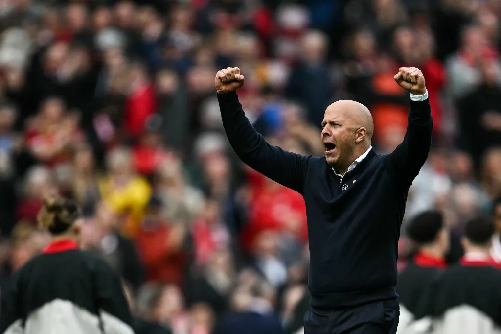 Liverpool's Dutch manager Arne Slot celebrates at the end of the English Premier League football match between Liverpool and West Ham United at Anfield in Liverpool, north west England on April 13, 2025. Liverpool wins 2 - 1 against West Ham United. (Photo by Paul ELLIS / AFP) / RESTRICTED TO EDITORIAL USE. No use with unauthorized audio, video, data, fixture lists, club/league logos or 'live' services. Online in-match use limited to 120 images. An additional 40 images may be used in extra time. No video emulation. Social media in-match use limited to 120 images. An additional 40 images may be used in extra time. No use in betting publications, games or single club/league/player publications. / 