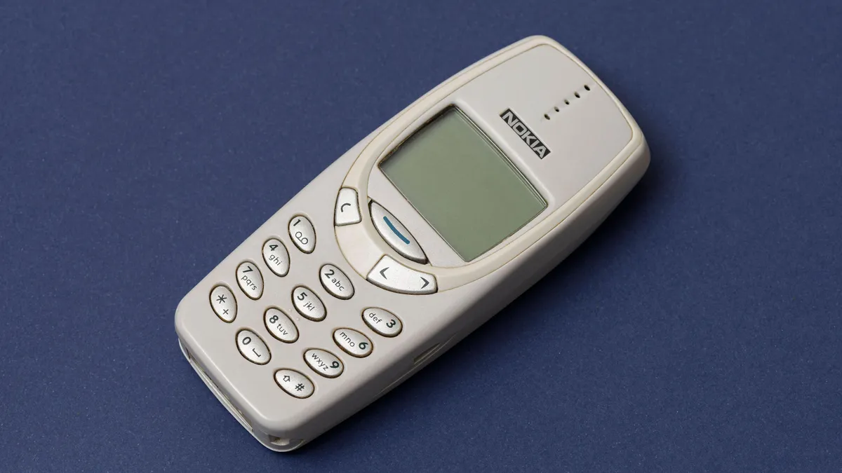 ISTANBUL, TURKEY - DECEMBER 18 2021: Cell phone Nokia 3310 on the blue background.