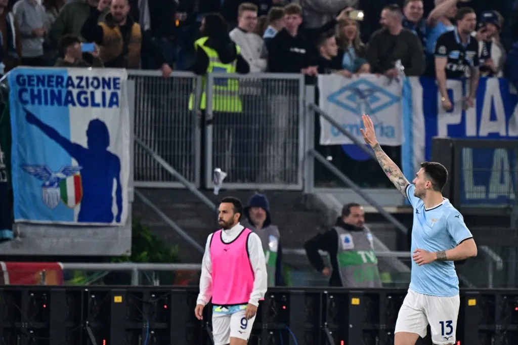 Lazio's Italian defender #13 Alessio Romagnoli celebrates scoring his team's first goal during the Italian Serie A football match between Lazio and Roma at the Olympic Stadium in Rome on April 13, 2025. (Photo by Tiziana FABI / AFP)