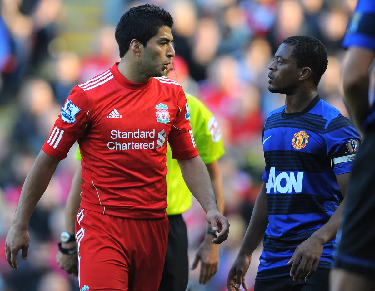 Liverpool's Uruguayan forward Luis Suárez (L) exchanges words with Manchester United's French defender Patrice Evra during the English Premier League football match between Liverpool and Manchester United at Anfield in Liverpool, north-west England, on October 15 2011. Liverpool have denied on October 16 Suarez abused Evra during the match, the BBC reported. French and British media quoted Evra after the game as telling French broadcaster Canal+ that Suarez had racially abused him several times during the match.   AFP PHOTO / ANDREW YATES
RESTRICTED TO EDITORIAL USE. No use with unauthorized audio, video, data, fixture lists, club/league logos or live services. Online in-match use limited to 45 images, no video emulation. No use in betting, games or single club/league/player publications. (Photo by ANDREW YATES / AFP)
