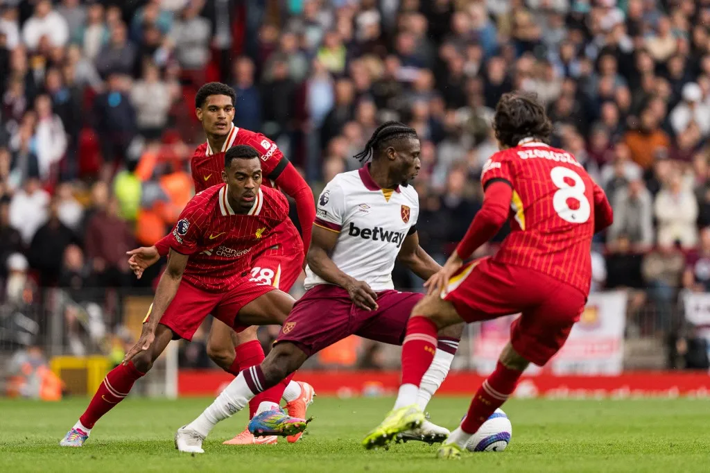 Mohammed Kudus of West Ham United is in action with Liverpool's Dominik Szoboszlai, Ryan Gravenberch, and Jarell Quansah during the Premier League match between Liverpool and West Ham United at Anfield in Liverpool, England, on April 13, 2025. (Photo by Steven Halliwell | MI News/NurPhoto) (Photo by MI News / NurPhoto / NurPhoto via AFP)