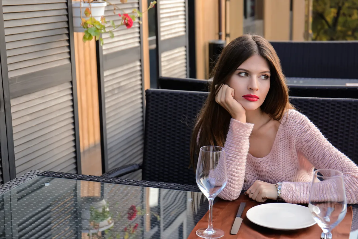Young woman waiting for her boyfriend in cafe