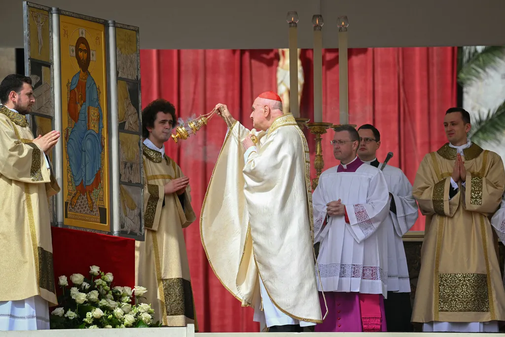 Cardinal Angelo Comastri presides over the Easter Mass as part of the Holy Week celebrations, at St Peter's square in the Vatican on April 20, 2025. (Photo by Andreas SOLARO / AFP)