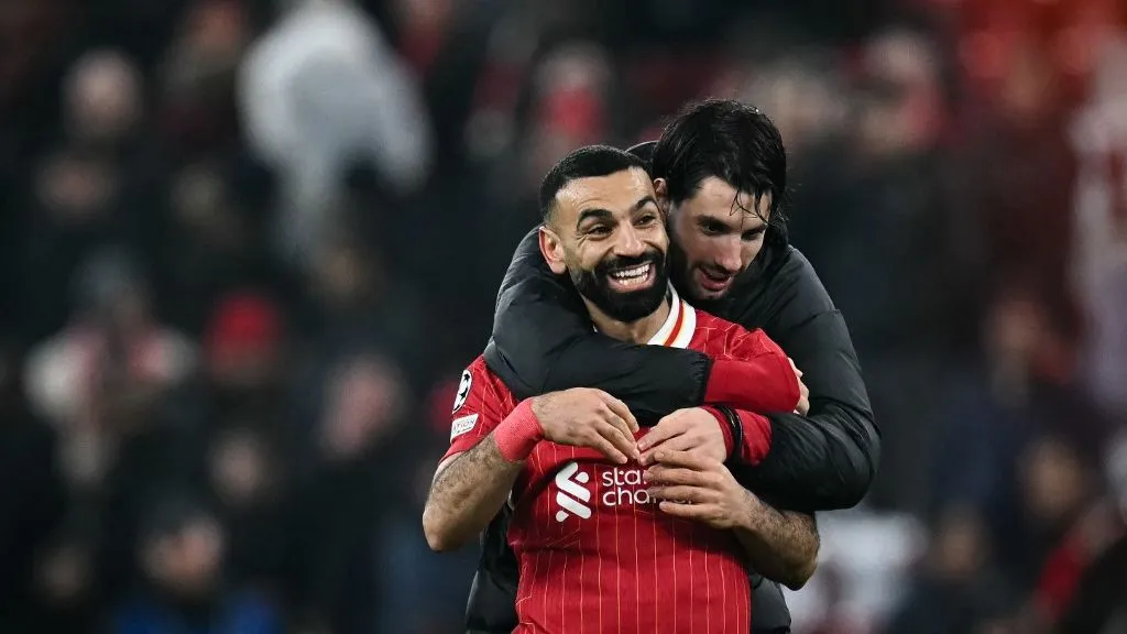 Liverpool's Egyptian striker #11 Mohamed Salah (front) and Liverpool's Hungarian midfielder #08 Dominik Szoboszlai (rear) celebrate at the end of the UEFA Champions League football match between Liverpool and Lille LOSC at Anfield in Liverpool, north west England on January 21, 2025. Liverpools won 2 - 1 against Lille LOSC. (Photo by Paul ELLIS / AFP)