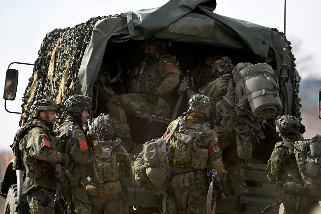 09 April 2025, Saxony-Anhalt, Gardelegen: German soldiers marked in red withdraw from the training town of Schnöggersburg. There they confront the enemy during the "Bastion Lion" exercise. The 17th Mechanized Infantry Battalion and the 42nd Mechanized Infantry Battalion of the Dutch brigade train for combat in urban areas. Meanwhile, the German Panzergrenadier Battalion 391 is practising defending sections of terrain of varying difficulty to enable the Dutch troops to fight. Photo: Klaus-Dietmar Gabbert/dpa (Photo by Klaus-Dietmar Gabbert / DPA / dpa Picture-Alliance via AFP)