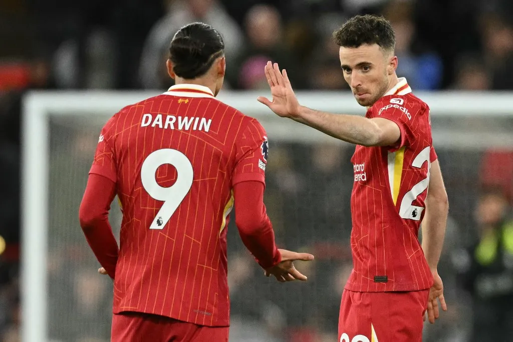 Liverpool's Portuguese striker #20 Diogo Jota (R) celebrates with Liverpool's Uruguayan striker #09 Darwin Nunez (L) after scoring their second goal during the English Premier League football match between Liverpool and Fulham at Anfield in Liverpool, north west England on December 14, 2024. (Photo by Oli SCARFF / AFP) / RESTRICTED TO EDITORIAL USE. No use with unauthorized audio, video, data, fixture lists, club/league logos or 'live' services. Online in-match use limited to 120 images. An additional 40 images may be used in extra time. No video emulation. Social media in-match use limited to 120 images. An additional 40 images may be used in extra time. No use in betting publications, games or single club/league/player publications. / 