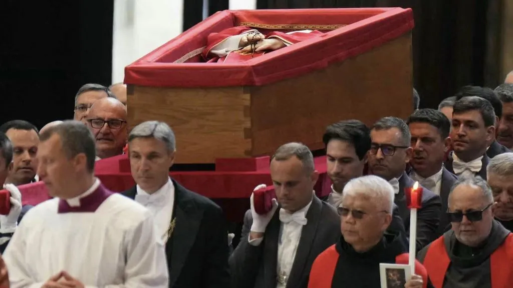 Pallbearers carry the coffin of the late Pope Francis inside St Peter's Basilica as it is transported in a procession from the chapel of Santa Marta to St Peter's Basilica, following the Pope's death, in the Vatican on April 23, 2025. The Pope died of a stroke, the Vatican announced hours after the death on April 21, 2025, of the 88-year-old reformer who inspired devotion but riled traditionalists during 12 years leading the Catholic Church. (Photo by Dimitar DILKOFF / AFP)