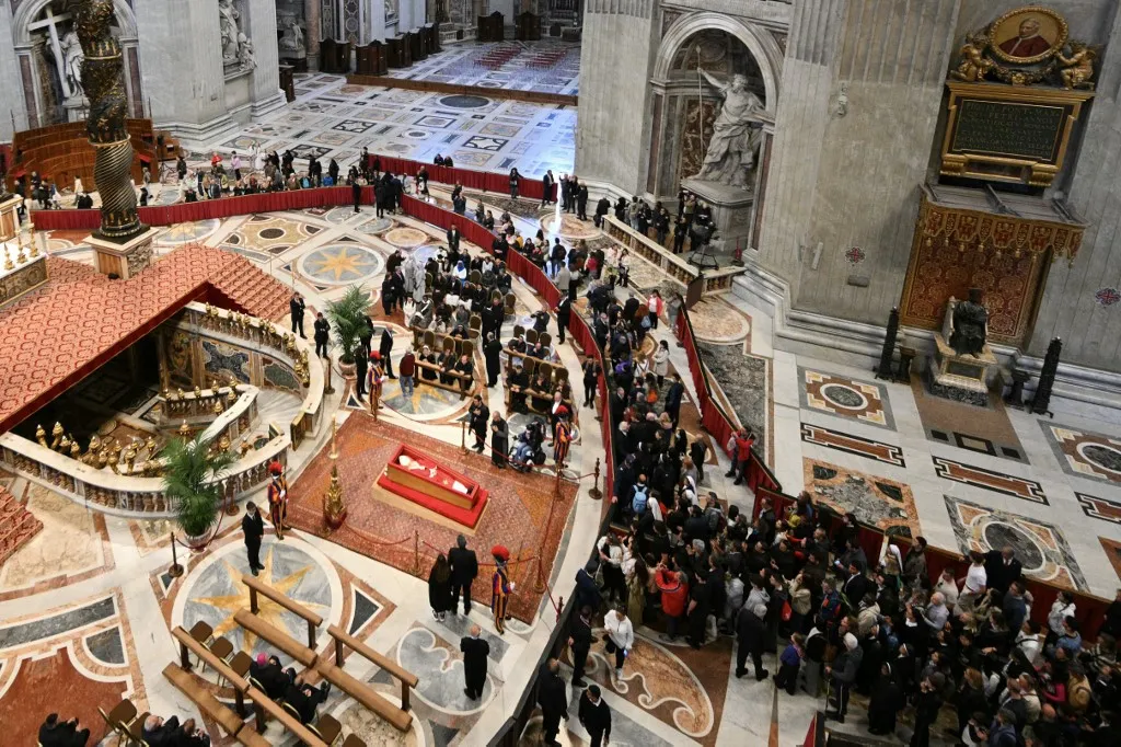 Visitors queue to pay their respects to late Pope Francis as he lies in state inside St Peter's Basilica in The Vatican, on April 24, 2025. The Vatican said on April 24, 2025, that nearly 50,000 people had so far paid their respects to Pope Francis, whose body is lying in state at St Peter's Basilica for three days before his funeral. (Photo by Andreas SOLARO / AFP)