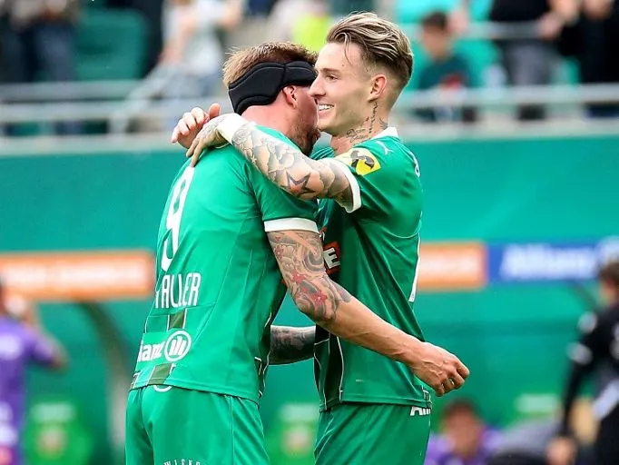 VIENNA, AUSTRIA - APRIL 13: Happy by Guido Burgstaller and Bendeguz Bolla of Rapid during the ADMIRAL Bundesliga match between SK Rapid and FK Austria Wien at Allianz Stadion on April 13, 2025 in Vienna, Austria.240413_SEPA_29_025 - 20250413_PD10512 (Photo by Thomas Pichler / APA-PictureDesk / APA-PictureDesk via AFP)