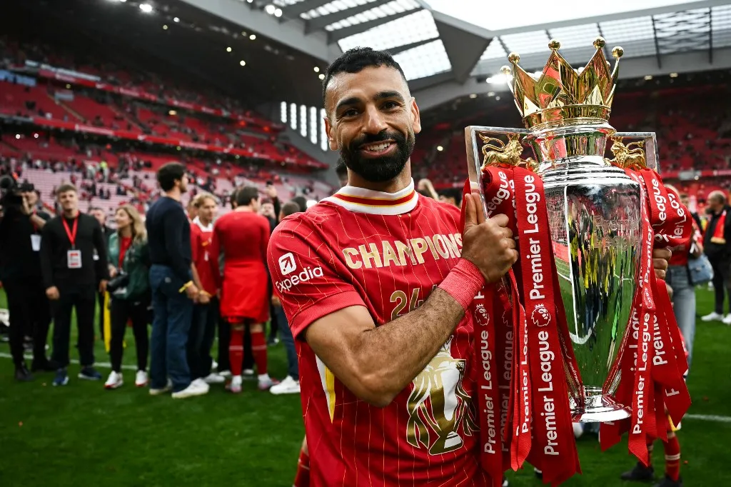 Liverpool's Egyptian striker #11 Mohamed Salah celebrates with the Premier League trophy at the end of the English Premier League football match between Liverpool and Crystal Palace at Anfield in Liverpool, north west England on May 25, 2025. Liverpool equalises 1 - 1 against Crystal Palace. (Photo by Paul ELLIS / AFP) / RESTRICTED TO EDITORIAL USE. No use with unauthorized audio, video, data, fixture lists, club/league logos or 'live' services. Online in-match use limited to 120 images. An additional 40 images may be used in extra time. No video emulation. Social media in-match use limited to 120 images. An additional 40 images may be used in extra time. No use in betting publications, games or single club/league/player publications. /