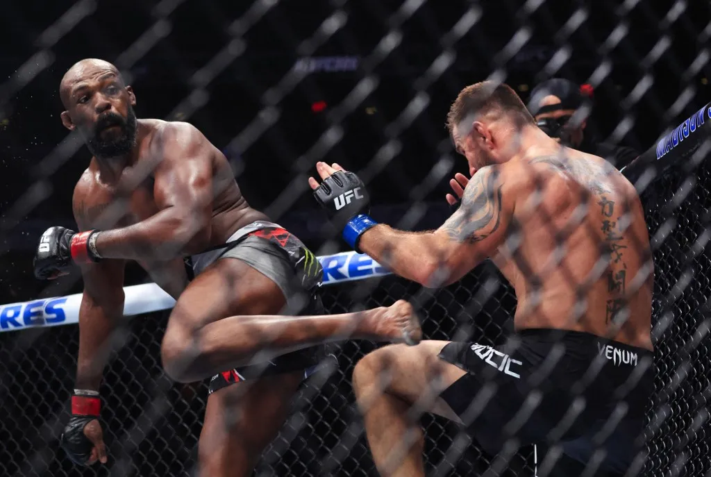 UFC Heavyweight Champion Jon Jones (L) kicks challenger Stipe Miocic (R) during their UFC 309 heavyweight title bout at Madison Square Garden in New York, on November 16, 2024. (Photo by Kena Betancur / AFP)