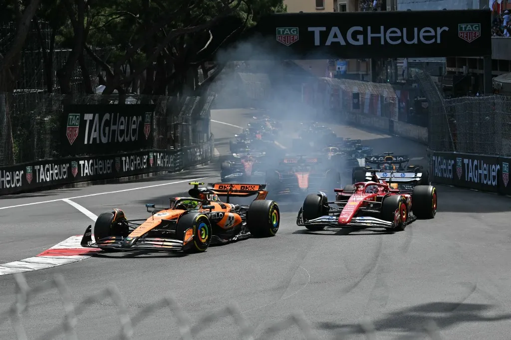McLaren's British driver Lando Norris (L) leads Ferrari's Monegasque driver Charles Leclerc (R) into the first corner during the Formula One Monaco Grand Prix at the Circuit de Monaco, on May 25, 2025. (Photo by Andrej ISAKOVIC / AFP)