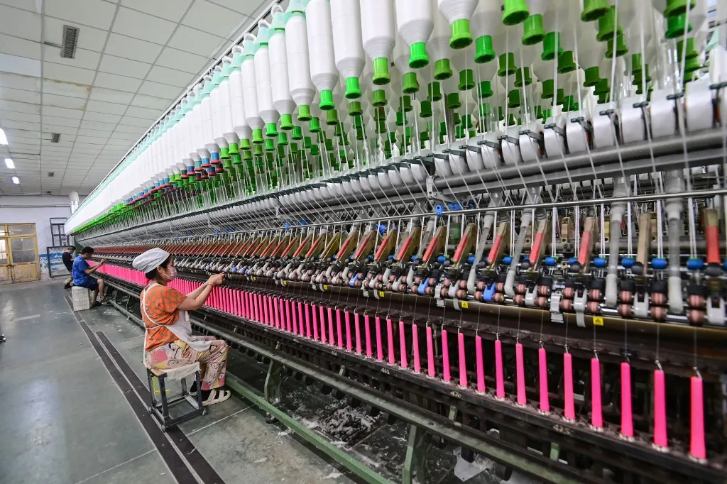 A worker works in a workshop of a textile products manufacturing enterprise in Qingzhou Economic Development Zone in Qingzhou City, Shandong Province, China, on May 10, 2025. (Photo by Costfoto/NurPhoto) (Photo by CFOTO / NurPhoto / NurPhoto via AFP)
