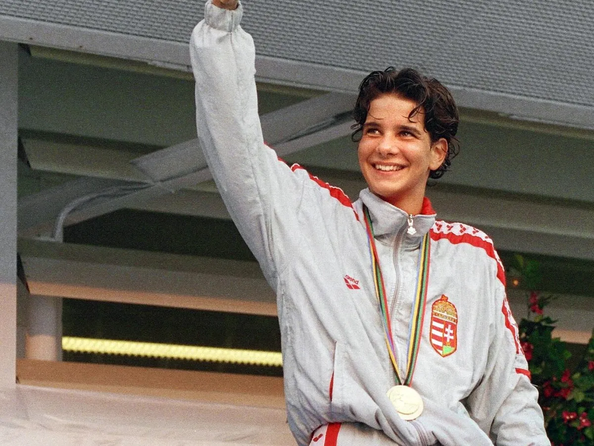 Hungarian Krisztina Egerszegi (1974-) waves the Hungarian flag, 31 July 1992, at the medal ceremony after she won the gold in the 200m backstroke at the 1992 Olympic Games in Barcelona. Three-time gold medal winner,100m and 200m backstroke, and 400m IM, in the1992 Olympics. At the age of 14, Egerszegi was the youngest ever to win a gold (200m backstroke) at the 1988 Olympic Games and silver (100m backstroke) and won her fifth gold at the 1996 Olympic Games in Atlanta. (Photo by IOPP / AFP)