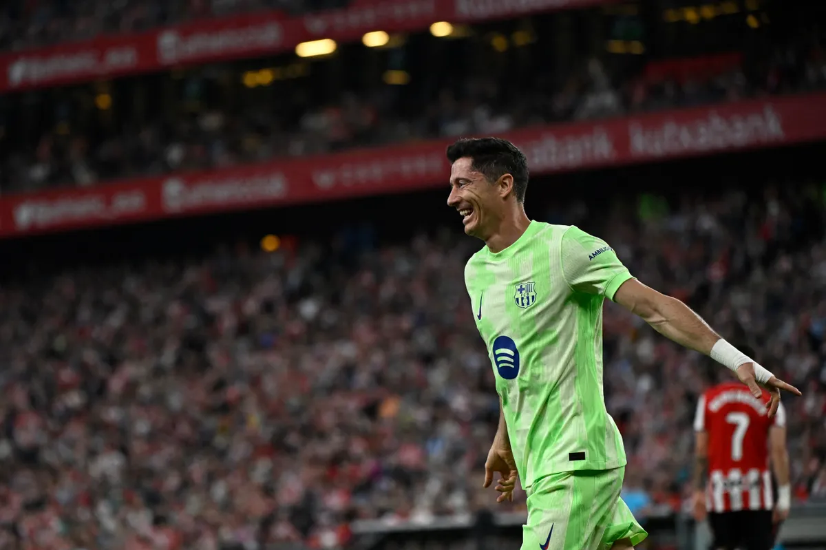 Barcelona's Polish forward #09 Robert Lewandowski celebrates scoring his second goal during the Spanish league football match between Athletic Club Bilbao and FC Barcelona at San Mames Stadium in Bilbao, on May 25, 2025. (Photo by ANDER GILLENEA / AFP)