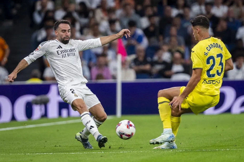 Daniel Carvajal of Real Madrid CF (L) competes for the ball against Sergi Cardona of Villarreal CF (R) during the La Liga EA Sports 2024/25 football match between Real Madrid CF and Villarreal CF at Estadio Santiago Bernabeu in Madrid, Spain, on October 5, 2024. (Photo by Alberto Gardin/NurPhoto) (Photo by Alberto Gardin / NurPhoto / NurPhoto via AFP)