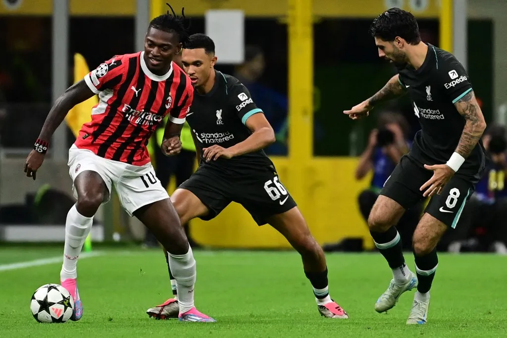 AC Milan's Portuguese forward #10 Rafael Leao (L) fights for the ball with Liverpool's English defender #66 Trent Alexander-Arnold and Liverpool's Hungarian midfielder #08 Dominik Szoboszlai during the UEFA Champions League 1st round day 1 football match between AC Milan and Liverpool FC at the San Siro stadium in Milan on September 17, 2024. (Photo by PIERO CRUCIATTI / AFP)