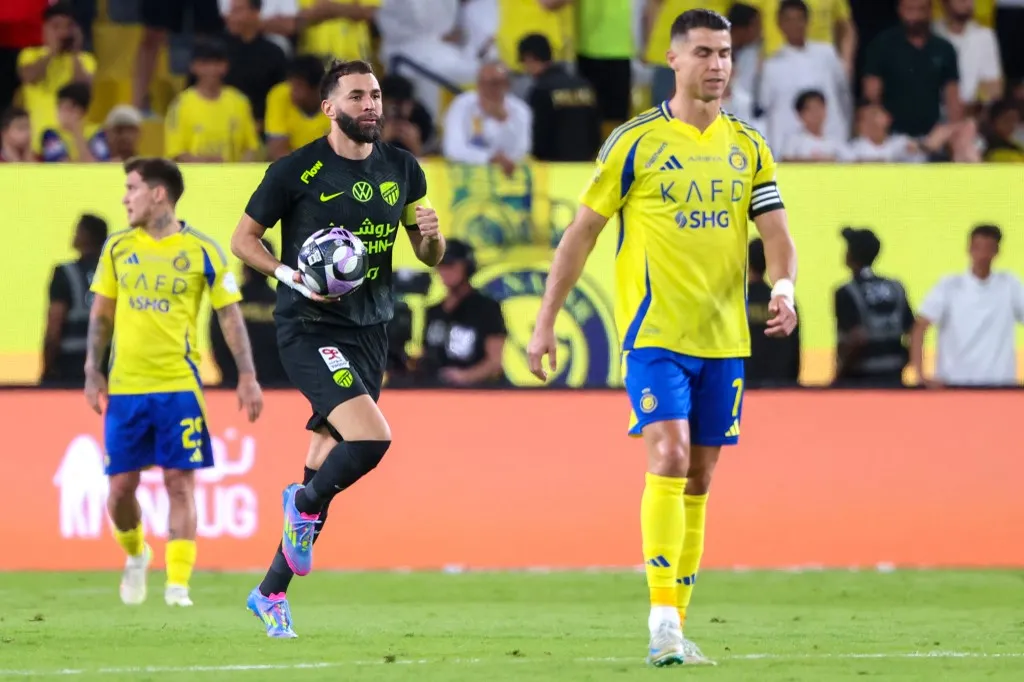 Nassr's Portuguese forward #7 Cristiano Ronaldo reacts as Ittihad's French forward #09 Karim Benzema celebrates scoring his team's first goal during the Saudi Pro League football match between Al-Nassr and Al-Ittihad at Al-Awwal Park in Riyadh on May 7, 2025. (Photo by Fayez NURELDINE / AFP)