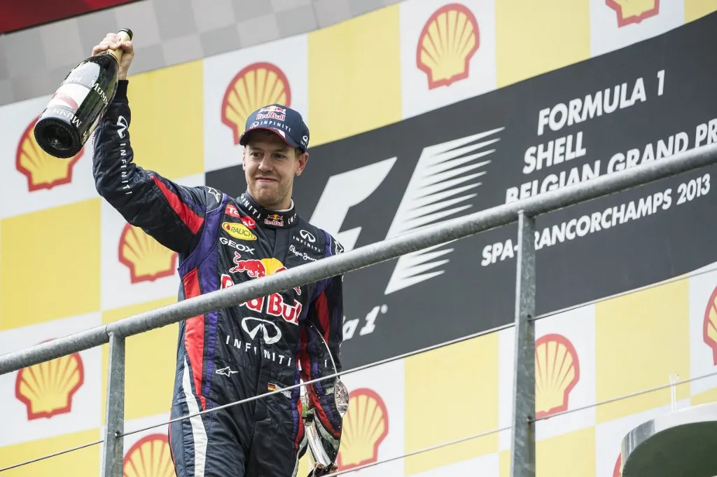 20130825 - SPA, BELGIUM: German Sebastian Vettel of Red Bull Racing celebrates on the podium after the Grand Prix F1 of Belgium, in Spa-Francorchamps, Sunday 25 August 2013. The Spa-Francorchamps Formula One Grand Prix takes place this weekend, from 23 August to 25 August. BELGA PHOTO ERIC LALMAND (Photo by ERIC LALMAND / BELGA MAG / Belga via AFP)