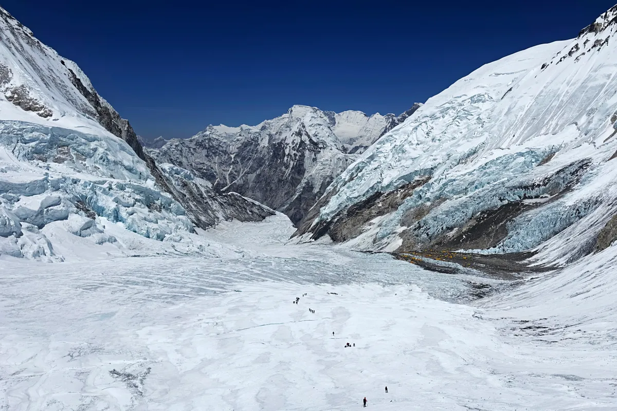 This photograph taken on May 3, 2024 shows mountaineers at the Khumbu Glacier during their ascend to Mount Everest's summit, in Nepal. A 54-year-old Nepalese climber known as "Everest Man" reached the peak of the world's highest mountain for a record 30th time on May 22, 2024, three decades after his first summit. (Photo by Tsering Pemba Sherpa / AFP)