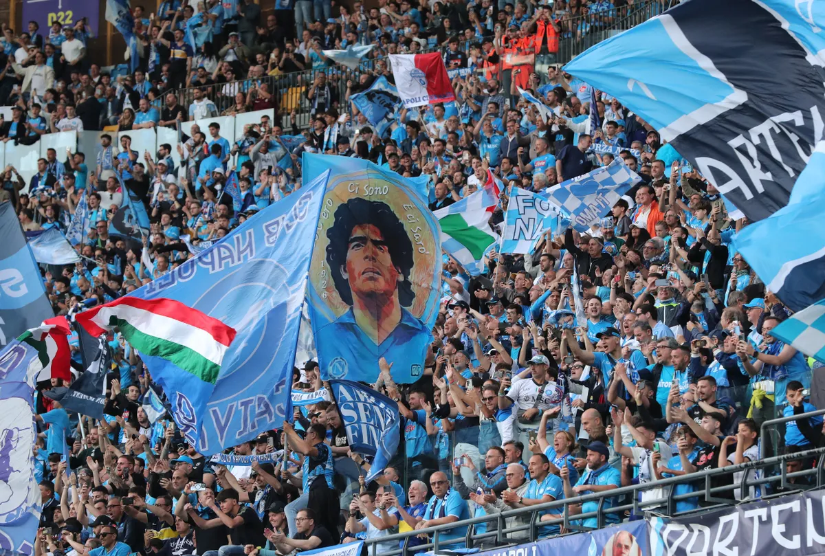 Napoli supporters cheer during the Italian Serie A football match between Napoli and Cagliari at the Diego Armando Maradona stadium in Naples on May 23, 2025. (Photo by Carlo Hermann / AFP)