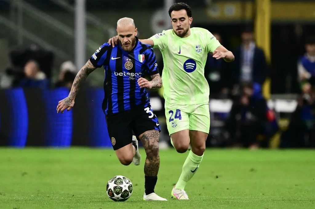 Inter Milan's Italian defender #32 Federico Dimarco and Barcelona's Spanish defender #24 Eric Garcia (R) fights for the ball during the UEFA Champions League semi-final second leg football match between Inter Milan and FC Barcelona at the San Siro stadium in Milan on May 6, 2025. (Photo by Marco BERTORELLO / AFP)