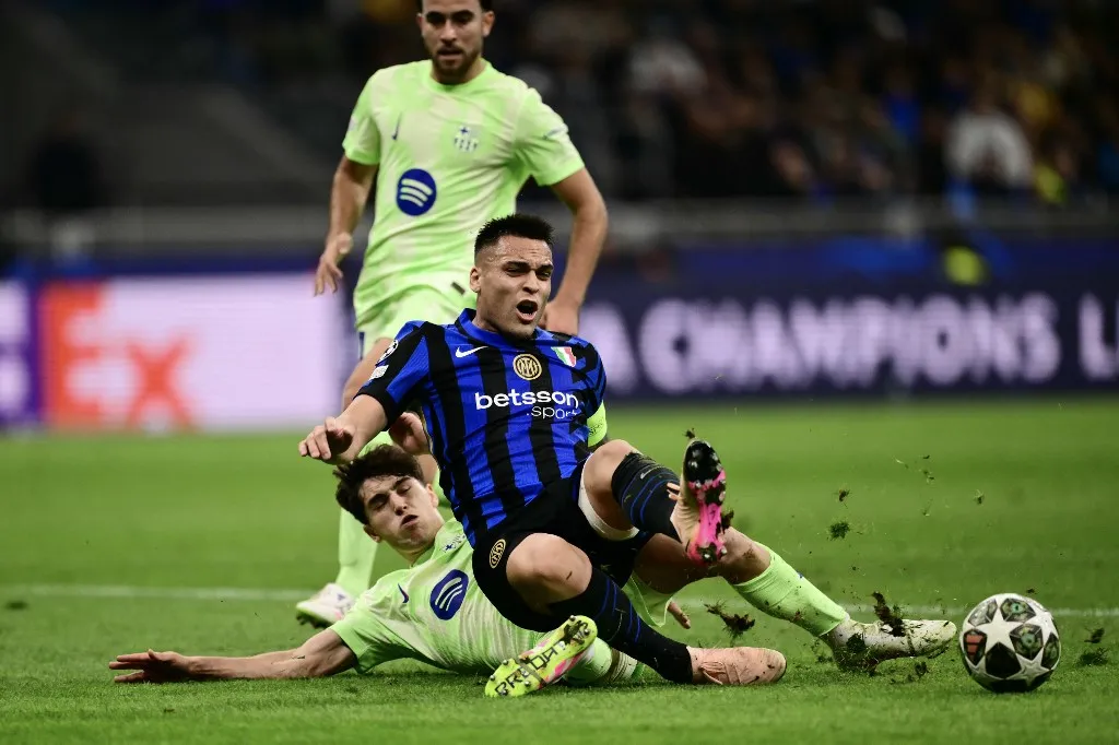 Barcelona's Spanish defender #02 Pau Cubarsi tackles Inter Milan's Argentine forward #10 Lautaro Martinez during the UEFA Champions League semi-final second leg football match between Inter Milan and FC Barcelona at the San Siro stadium in Milan on May 6, 2025. (Photo by Marco BERTORELLO / AFP)