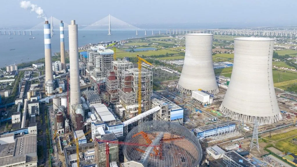Workers engage in construction at the Guoxin Shazhou 2?? 1,000,000-kilowatt unit expansion project site in Zhangjiagang City, Jiangsu Province, China, on May 8, 2025. (Photo by Costfoto/NurPhoto) (Photo by CFOTO / NurPhoto / NurPhoto via AFP)