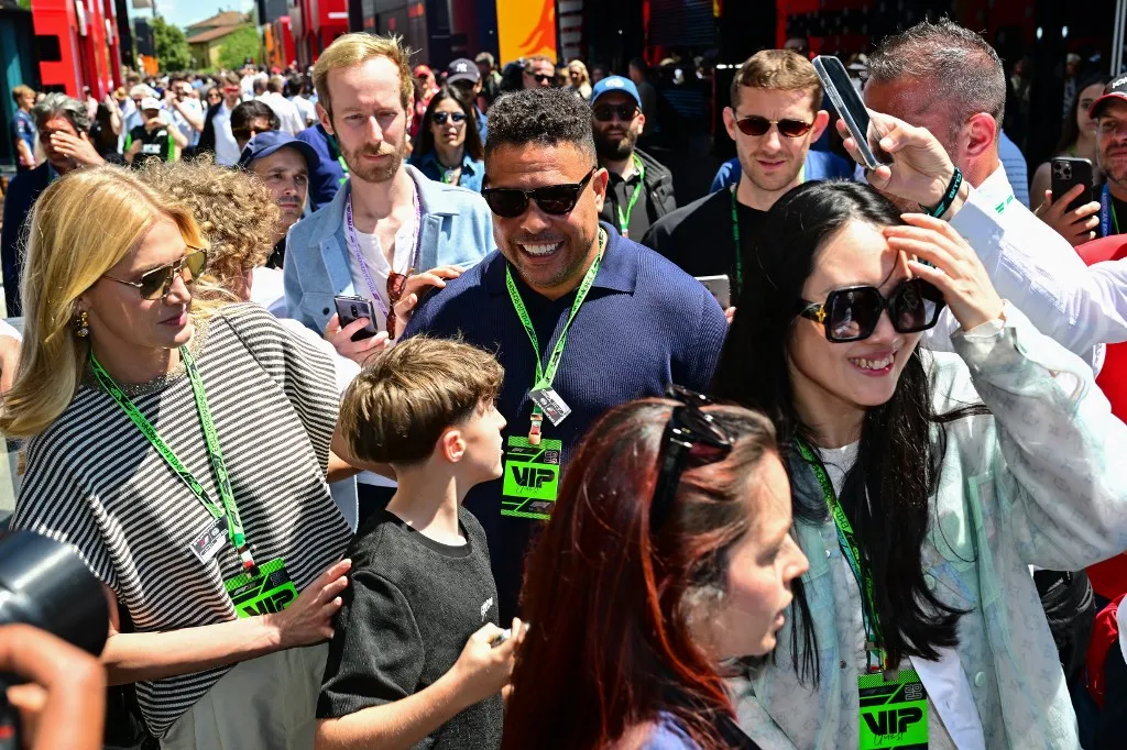 Brazilian football legend Ronaldo Nazario arrives with his wife Celina Locks to attend the 2025 Emilia Romagna Formula One Grand Prix at the Imola autodrome in Imola, on May 18, 2025. (Photo by Andrej ISAKOVIC / AFP)