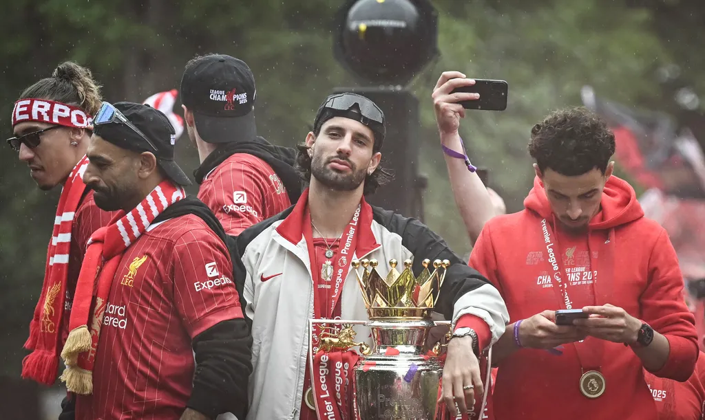 Szoboszlai, Szoboszlai Dominik, Liverpool's Hungarian midfielder #08 Dominik Szoboszlai celebrates with the Premier League trophy during an open-top bus victory parade for Liverpool's Premier League title win, in Liverpool, north-west England on May 26, 2