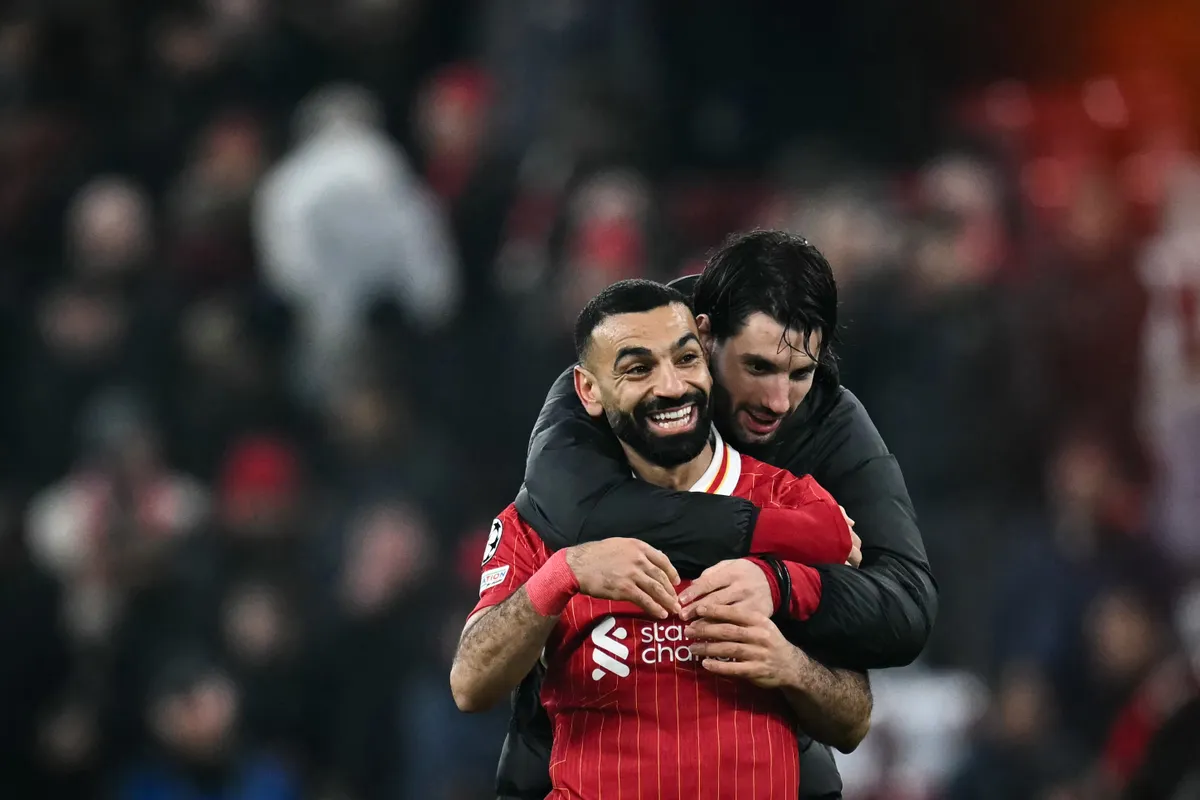 Szoboszlai Dominik, Liverpool's Egyptian striker #11 Mohamed Salah (front) and Liverpool's Hungarian midfielder #08 Dominik Szoboszlai (rear) celebrate at the end of the UEFA Champions League football match between Liverpool and Lille LOSC at Anfield in Liverpool, north west England on January 21, 2025. Liverpools won 2 - 1 against Lille LOSC. (Photo by Paul ELLIS / AFP)