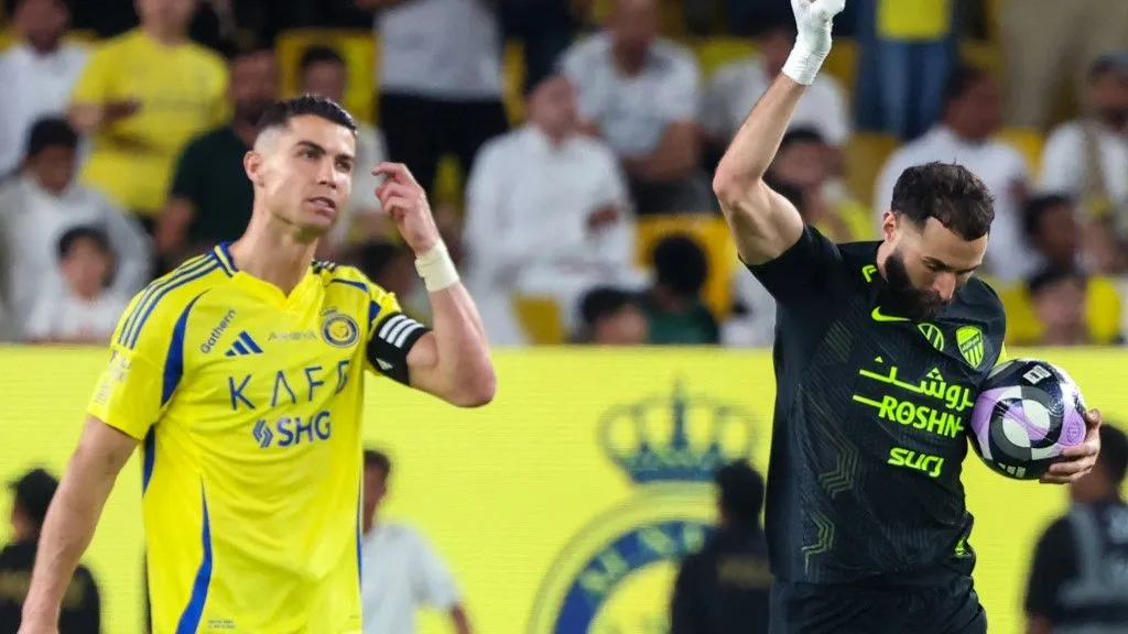 Nassr's Portuguese forward #7 Cristiano Ronaldo reacts as Ittihad's French forward #09 Karim Benzema celebrates scoring his team's first goal during the Saudi Pro League football match between Al-Nassr and Al-Ittihad at Al-Awwal Park in Riyadh on May 7, 2025. (Photo by Fayez NURELDINE / AFP)