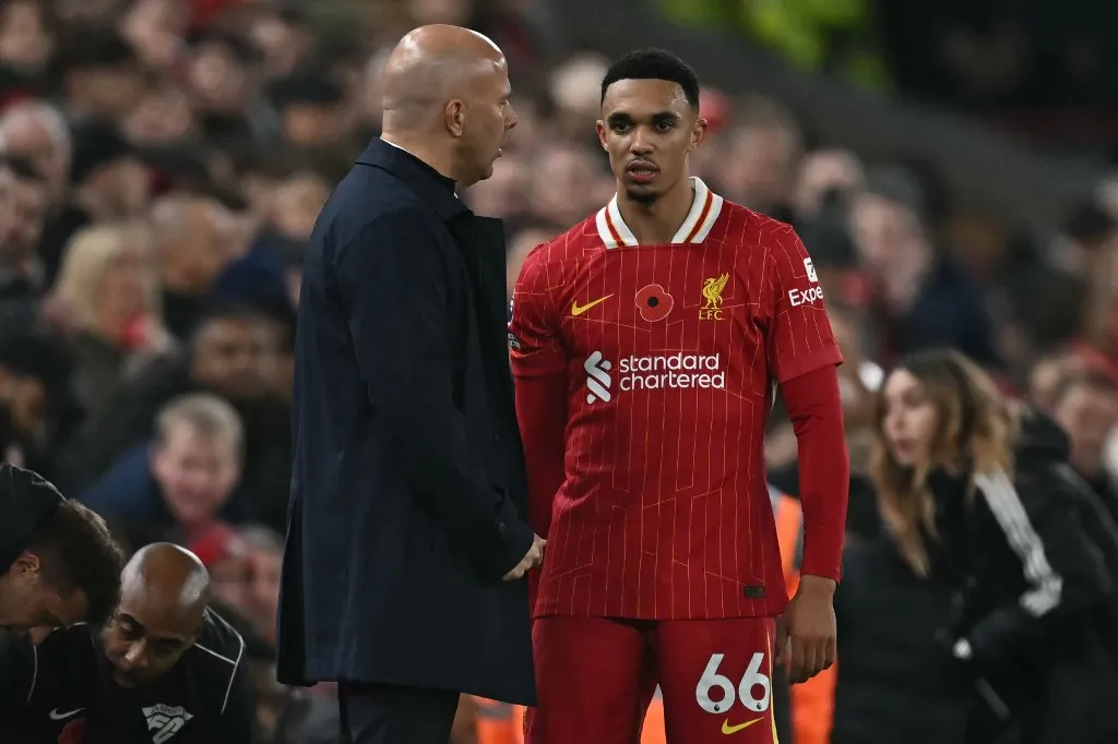 Liverpool's Dutch manager Arne Slot (L) speaks with Liverpool's English defender #66 Trent Alexander-Arnold (R) after he leaves the game injured, during the English Premier League football match between Liverpool and Aston Villa at Anfield in Liverpool, north west England on November 9, 2024. (Photo by Paul ELLIS / AFP) / RESTRICTED TO EDITORIAL USE. No use with unauthorized audio, video, data, fixture lists, club/league logos or 'live' services. Online in-match use limited to 120 images. An additional 40 images may be used in extra time. No video emulation. Social media in-match use limited to 120 images. An additional 40 images may be used in extra time. No use in betting publications, games or single club/league/player publications. / 