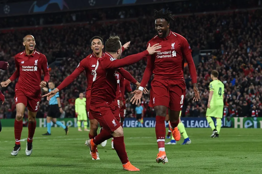Liverpool's Belgium striker Divock Origi (R) celebrates wtih Liverpool's Swiss midfielder Xherdan Shaqiri after scoring their fourth goal during the UEFA Champions league semi-final second leg football match between Liverpool and Barcelona at Anfield in Liverpool, north west England on May 7, 2019. (Photo by Paul ELLIS / AFP)