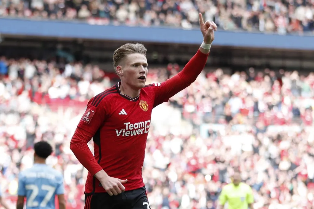 Manchester United's Scottish midfielder #39 Scott McTominay celebrates after scoring the opening goal of the English FA Cup semi-final football match between Coventry City and Manchester United at Wembley Stadium in north west London on April 21, 2024. (Photo by Ian Kington / AFP) / NOT FOR MARKETING OR ADVERTISING USE / RESTRICTED TO EDITORIAL USE