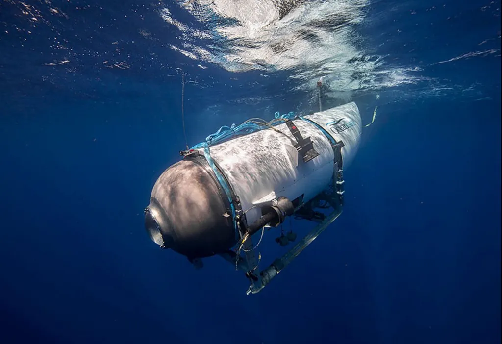 This undated image courtesy of OceanGate Expeditions, shows their Titan submersible beginning a descent. Rescue teams expanded their search underwater on June 20, 2023, as they raced against time to find a Titan deep-diving tourist submersible that went missing near the wreck of the Titanic with five people on board and limited oxygen. All communication was lost with the 21-foot (6.5-meter) Titan craft during a descent June 18 to the Titanic, which sits at a depth of crushing pressure more than two miles (nearly four kilometers) below the surface of the North Atlantic. (Photo by Handout / OceanGate Expeditions / AFP) / RESTRICTED TO EDITORIAL USE - MANDATORY CREDIT "AFP PHOTO / OceanGate Expeditions" - NO MARKETING NO ADVERTISING CAMPAIGNS - DISTRIBUTED AS A SERVICE TO CLIENTS