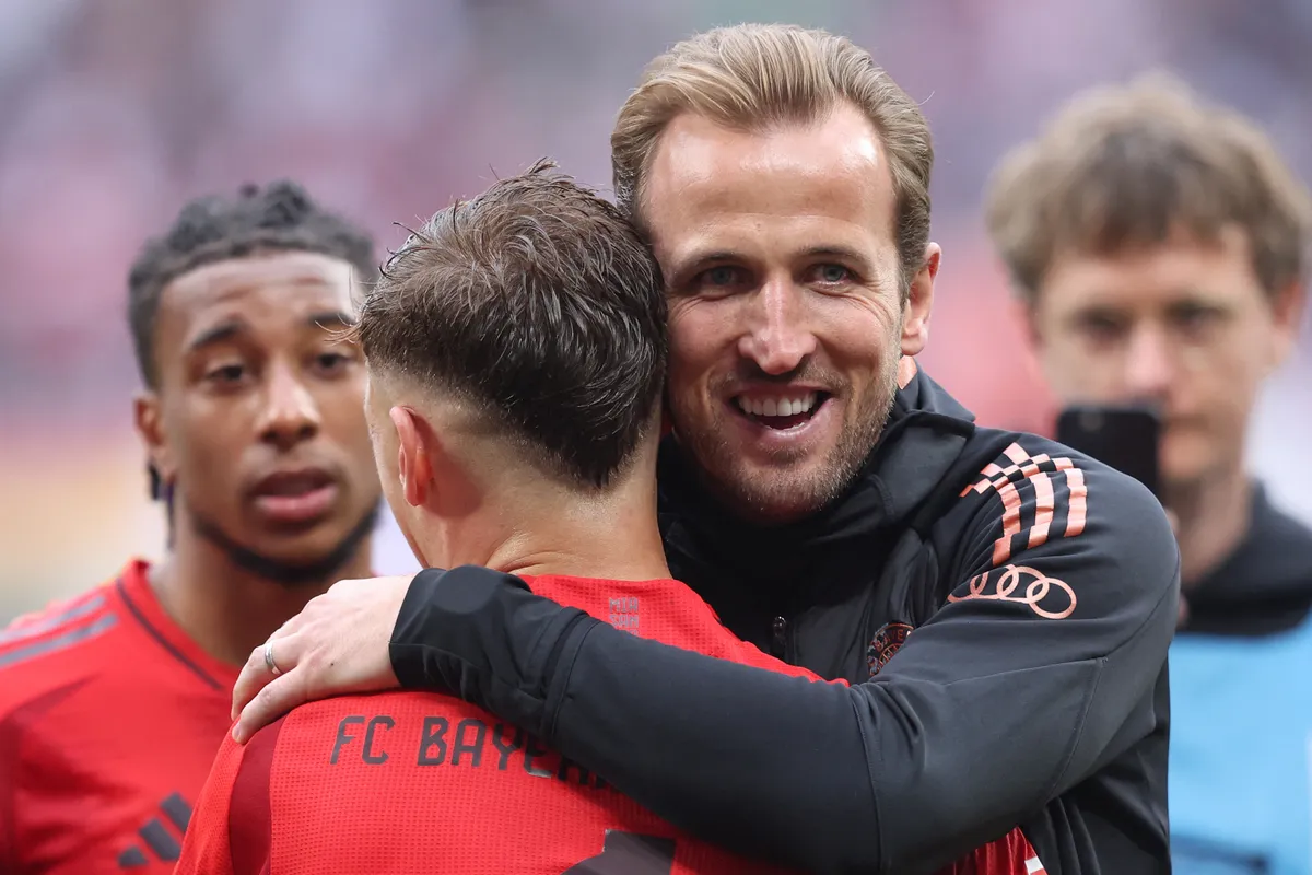 (FILES) Bayern Munich's English forward #09 Harry Kane hugs Bayern Munich's German midfielder #06 Joshua Kimmich after the German first division Bundesliga football match between RB Leipzig and FC Bayern Munich in Leipzig, eastern Germany on May 3, 2025. Bayern Munich won the league on May 4, 2025 for the 34th time after Leverkusen failed to win away to Freiburg with English forward Harry Kane winning his first title. (Photo by RONNY HARTMANN / AFP)