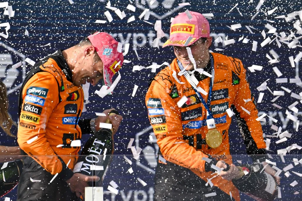 MIAMI, UNITED STATES - MAY 04: Lando Norris (L) of Great Britain McLaren F1 Team wins the second place and Oscar Piastri (R) of Australia McLaren F1 Team wins first place and celebrate on the podium during the F1 Grand Prix of Miami at Miami International Autodrome on May 04, 2025 in Miami, Florida. Miguel J. Rodriguez Carrillo / Anadolu (Photo by Miguel J. Rodriguez Carrillo / ANADOLU / Anadolu via AFP)