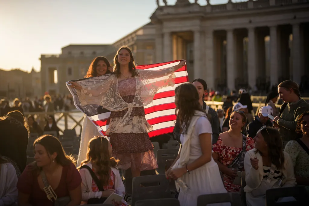 VATICAN CITY, VATICAN - MAY 18:  Faithful wave with an American flag ahead of the Inauguration Mass of Pope Leo XIV in St Peter's Square on May 18, 2025 in Vatican City, Vatican. Pope Leo XIV (formerly Cardinal Robert Francis Prevost) presided over his inauguration mass in St Peter's Square after his election on May 8th. (Photo by Christopher Furlong/Getty Images)