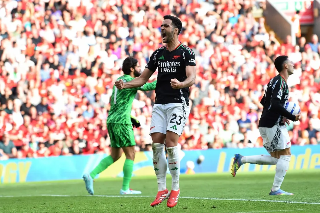 Arsenal's Spanish midfielder #23 Mikel Merino celebrates after scoring their second goal during the English Premier League football match between Liverpool and Arsenal at Anfield in Liverpool, north west England on May 11, 2025. (Photo by PETER POWELL / AFP) / RESTRICTED TO EDITORIAL USE. No use with unauthorized audio, video, data, fixture lists, club/league logos or 'live' services. Online in-match use limited to 120 images. An additional 40 images may be used in extra time. No video emulation. Social media in-match use limited to 120 images. An additional 40 images may be used in extra time. No use in betting publications, games or single club/league/player publications. / 