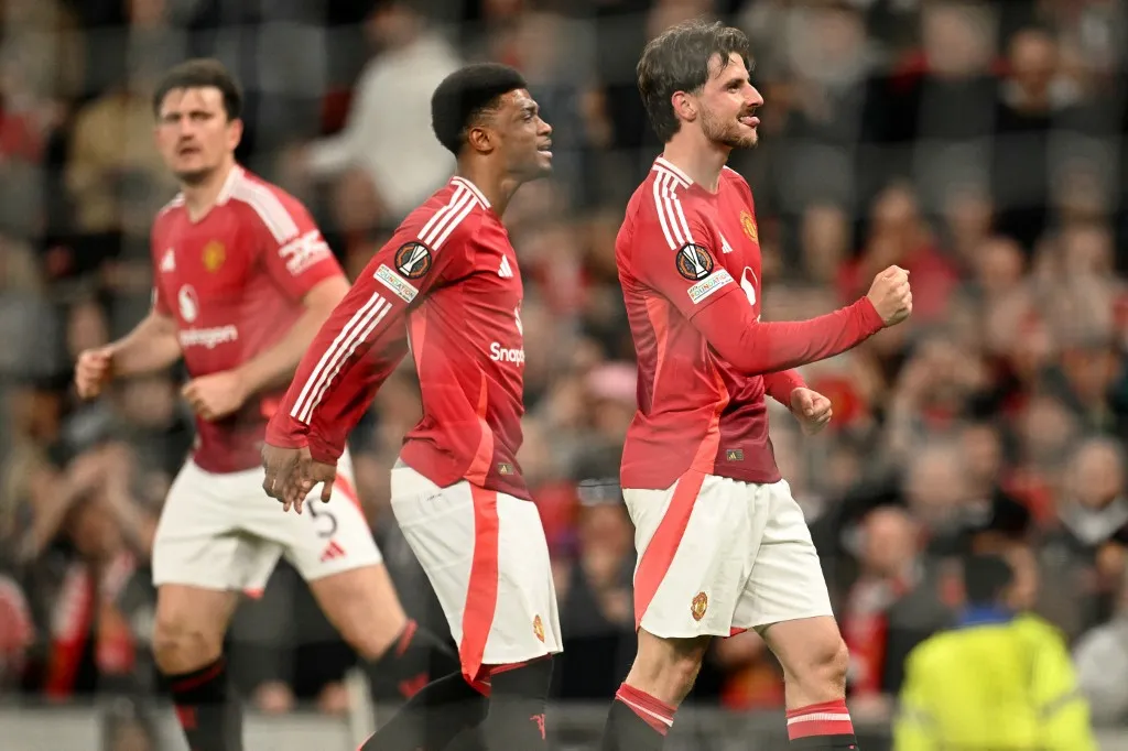 Manchester United's English midfielder #07 Mason Mount (R) celebrates after scoring Manchester United's first goal during the UEFA Europa League semi final second leg football match between Manchester United and Athletic Club Bilbao at Old Trafford stadium in Manchester, north west England, on May 8, 2025. (Photo by Oli SCARFF / AFP)